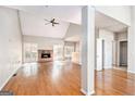 Spacious living room with hardwood floors, vaulted ceilings, brick fireplace, and sun-filled windows at 4875 Ben Hill Rd, College Park, GA 30349