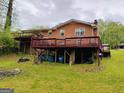 Multi-level deck at rear of brick home with lush lawn at 6501 River Run Rd, Riverdale, GA 30274