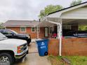 Covered parking with brick columns and view of front door and car port at 6501 River Run Rd, Riverdale, GA 30274