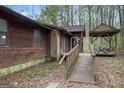 Charming home exterior with wood ramp leading to front door and quaint gazebo nearby at 655 Sunset Dr, Locust Grove, GA 30248