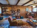 Inviting living room with wood paneled walls, exposed beams, and comfortable seating at 1667 Park Pl, Lithia Springs, GA 30122