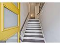 The home features a bright entryway with freshly painted walls and wood stairs at 1149 Ansel Nw Ln, Atlanta, GA 30318