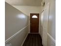 Inviting entryway featuring a wood door, a white closet door and luxury vinyl plank flooring at 7560 Taylor Rd # 5, Riverdale, GA 30274