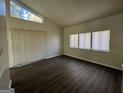 Bright living room with high ceilings, luxury vinyl plank flooring, and large windows at 7560 Taylor Rd # 5, Riverdale, GA 30274