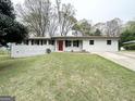 Charming ranch-style home with a freshly painted exterior and meticulously maintained lawn at 6026 S Bear Dr, Douglasville, GA 30135