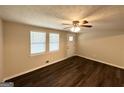 Inviting living room featuring new flooring, neutral walls, ceiling fan, and natural light at 6026 S Bear Dr, Douglasville, GA 30135