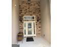 Inviting front door with stone surround, decorative glass, and elegant lighting at 6279 Giles Rd, Lithonia, GA 30058