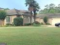Lush front yard with mature landscaping and a well-kept lawn at 6279 Giles Rd, Lithonia, GA 30058