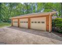 Spacious three-car garage with brick exterior and ample parking space at 205 Olde Oak Dr, Jonesboro, GA 30238