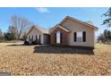 A close exterior shot of the home showing the brick and siding detail at 321 Harris Ave, Locust Grove, GA 30248