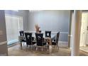 Dining room with modern mirrored table, six black chairs, chandelier and bright windows at 1622 Brentwood Se Xing, Conyers, GA 30013