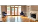 Bright living room featuring hardwood floors, a fireplace, and french doors leading to a deck at 1622 Brentwood Se Xing, Conyers, GA 30013