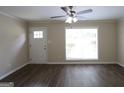 Bright living room with new flooring, a fan, and ample natural light at 3578 Sherbrooke Sw Way, Atlanta, GA 30331