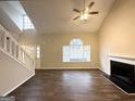 Inviting living room featuring high ceilings, a fireplace, laminate flooring and natural light at 3228 Rivermist Cv, Decatur, GA 30034