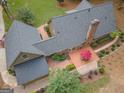 Aerial view showcasing the home's roof, back deck with umbrella, and the well-manicured yard at 107 Rolling Grn, Peachtree City, GA 30269