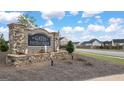 Stone entrance sign for The Gates at Pates Creek community with manicured landscaping and water feature at 675 Edgar St, Hampton, GA 30228