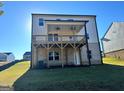 A well-maintained backyard featuring a covered deck and access to the basement at 1704 Goodwin Dr, Hampton, GA 30228