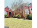 Beautiful brick home featuring mature landscaping and a well-manicured lawn at 1090 Crown River Pkwy, Mcdonough, GA 30252