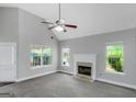 Spacious living room with vaulted ceilings, large windows and cozy fireplace at 100 Hugh Dr, Covington, GA 30016