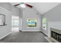 Open living area featuring a corner fireplace, ceiling fan and neutral decor at 100 Hugh Dr, Covington, GA 30016