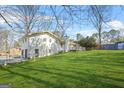 Spacious backyard featuring lush green grass and a back view of the home with a deck at 2511 Due West Nw Cir, Kennesaw, GA 30152