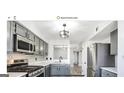 Modern kitchen boasts stainless steel appliances, sleek cabinetry, and a stylish backsplash at 9453 Cypress Ln, Jonesboro, GA 30238