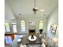 An overhead view of the living room featuring abundant natural light and a cozy fireplace at 2481 Weatherstone Cir, Conyers, GA 30094