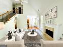 Bright, airy living room featuring a fireplace and a staircase with wrought iron spindles at 2481 Weatherstone Cir, Conyers, GA 30094