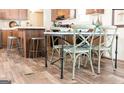 A dining table with a view of a modern kitchen with wooden cabinets and granite countertops at 54 Holly Dr, Carrollton, GA 30116