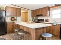 Modern kitchen with wood cabinets, granite countertops and stainless steel appliances at 54 Holly Dr, Carrollton, GA 30116