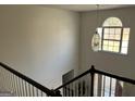 Foyer view with a window, chandelier, and stairs with wooden railings, and front door at 888 Shadow Lakes Dr, Lithonia, GA 30058