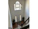 Foyer view of the staircase, chandelier, front door, and decor at 888 Shadow Lakes Dr, Lithonia, GA 30058