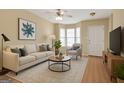 Cozy living room boasts hardwood floors, a couch, and natural light at 7112 Brookview Way, Riverdale, GA 30274