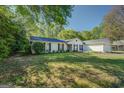 This home features a large front yard and beautiful landscaping at 2340 Rolling Acres Sw Dr, Conyers, GA 30094