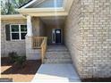 Inviting brick home featuring a covered front porch and steps leading to the front door at 3383 Milan Ct # 4 Plapprox Sqft 1, Douglasville, GA 30135