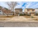 Charming two-story home featuring neutral siding, black shutters, manicured landscaping, and a concrete driveway at 103 Watercress Ct, Stockbridge, GA 30281