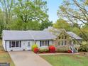 Aerial view of lovely one-story home with landscaped front yard, stone accents, and a long driveway at 121 Cotton Indian Trl, Stockbridge, GA 30281