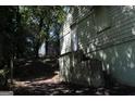 Exterior view features access steps and weathered siding, with glimpses of surrounding greenery at 346 Schoen Se St, Atlanta, GA 30315