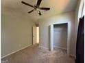 Bedroom with neutral walls, carpet, ceiling fan and closet, offering a simple and clean aesthetic at 10119 Commons Way, Jonesboro, GA 30238