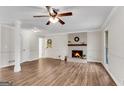 Spacious living room with hardwood floors, a ceiling fan, and a fireplace at 9055 Carroll Manor Dr, Sandy Springs, GA 30350