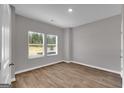 Sun-filled bedroom featuring wood-look flooring and two large windows at 5326 Tolar Rd # 29, South Fulton, GA 30213