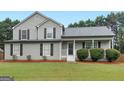 Charming two-story home with manicured lawn and attractive landscaping at 303 Mill Glen Ct, Mcdonough, GA 30252