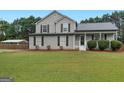 Charming two-story home with manicured lawn and attractive landscaping at 303 Mill Glen Ct, Mcdonough, GA 30252