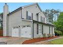 A two-car garage is attached to the home, offering ample parking space at 303 Mill Glen Ct, Mcdonough, GA 30252