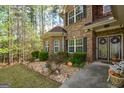 Inviting front porch with landscaped garden and a secure Vivint security system at 4360 Derrick Rd, South Fulton, GA 30349