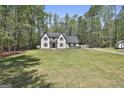 Spacious two-story home with a large, well-maintained lawn and mature trees at 214 Windgate Ct, Peachtree City, GA 30269