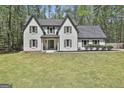 Charming two-story home featuring a grey roof, white brick facade, and well-manicured front yard at 214 Windgate Ct, Peachtree City, GA 30269