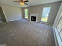 Spacious living room featuring a fireplace, neutral walls, and ample natural light from large windows at 194 Bay Court Dr, Stockbridge, GA 30281