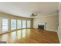 Spacious living room with fireplace, ceiling fan and access to a outdoor deck at 1201 Turtle Creek Ct, Lawrenceville, GA 30043