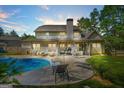 Backyard oasis featuring a pristine pool, patio seating, and covered outdoor kitchen, perfect for entertaining at 229 Primstone Way, Mcdonough, GA 30253